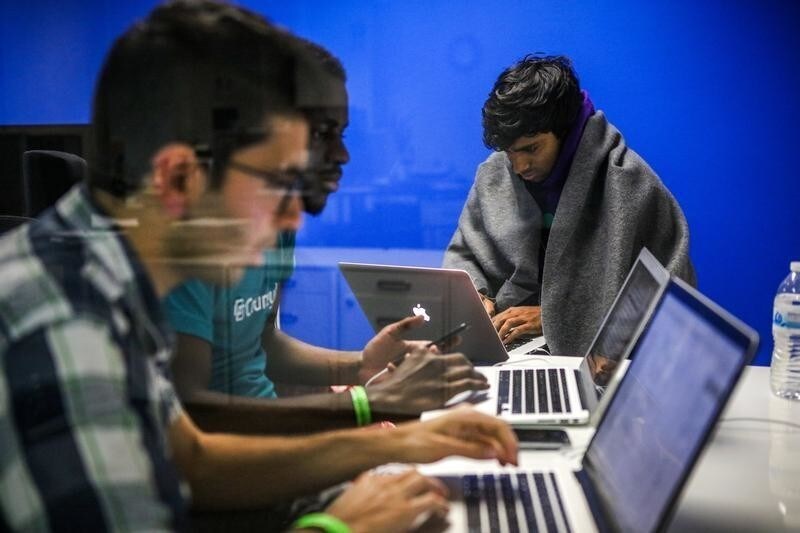 Mehmet Efe Akengin, Hassan Kane and Surya Bhupatiraju (L-R) work late into the night on computers during a weekend Hackathon event, in San Francisco, California, U.S. July 17, 2016. REUTERS/Gabrielle Lurie SEARCH "LURIE TECH" FOR THIS STORY. SEARCH "WIDER IMAGE" FOR ALL STORIES. - RC1AF611F530