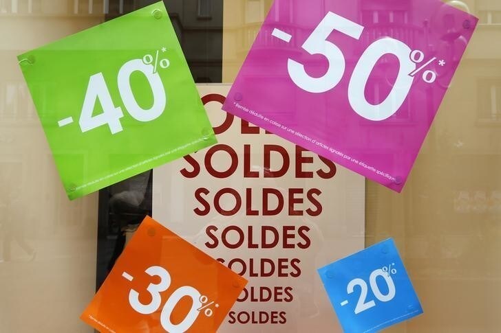 Discount signs are displayed in a clothing store window in Strasbourg during the first day of summer sales in France, June 26, 2013. REUTERS/Vincent Kessler (FRANCE - Tags: BUSINESS SOCIETY)