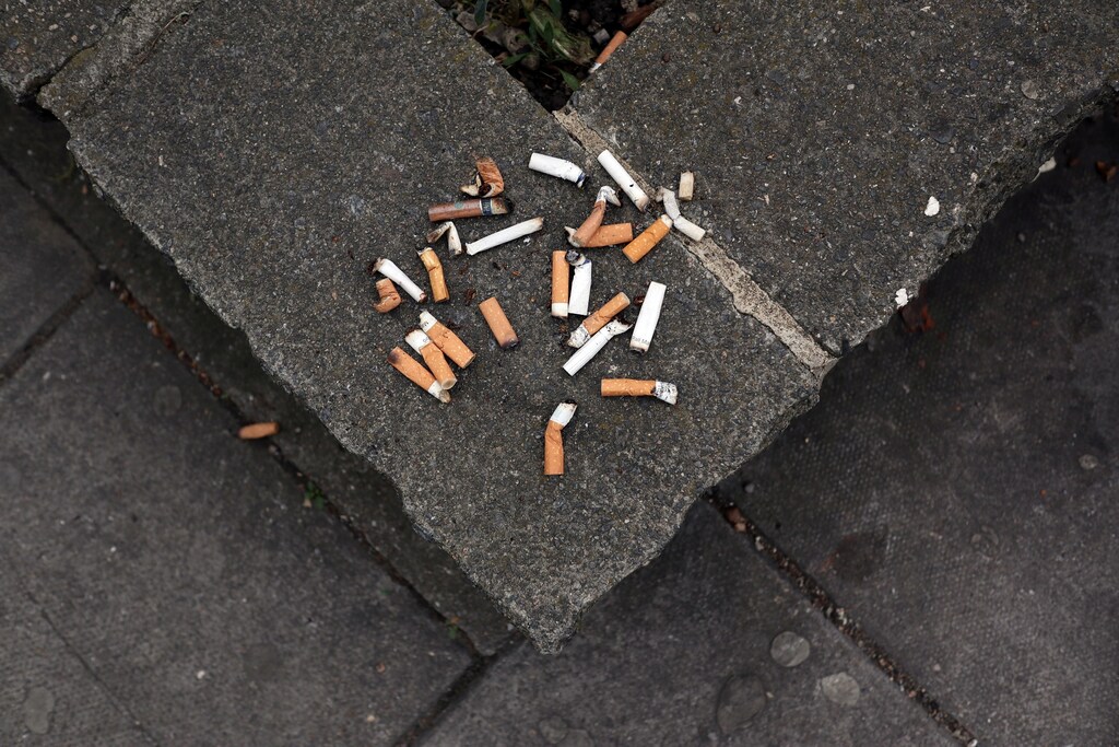 Cigarette butt ends are seen discarded on a public flower bed wall in London, Britain May 9, 2017. REUTERS/Russell Boyce - RC1BAAAD0820