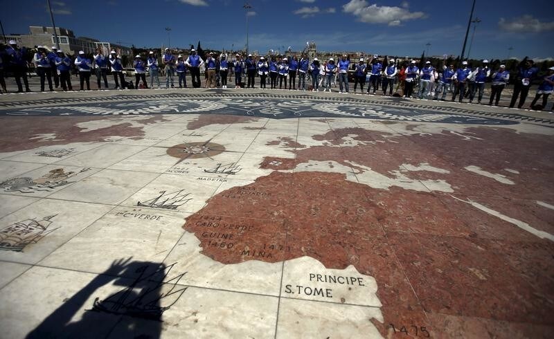 A group of volunteers gather on a square decorated with a giant world map, during Earth Day celebrations in Lisbon April 22, 2015. Volunteers held placards with letters forming the sentence "We take care of the Earth". Earth Day, which promotes awareness and protection of the environment, is celebrated annually on April 22. REUTERS/Rafael Marchante - GF10000068787