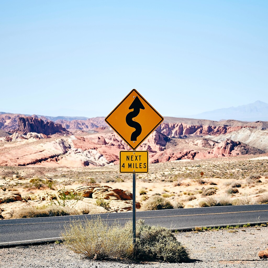 Road sign in the desert show curved arrow upwards stating "Next 4 Miles" underneath: Leaders of the World Economic Forum’s Innovators Community speak about how they adapt to today's realities.