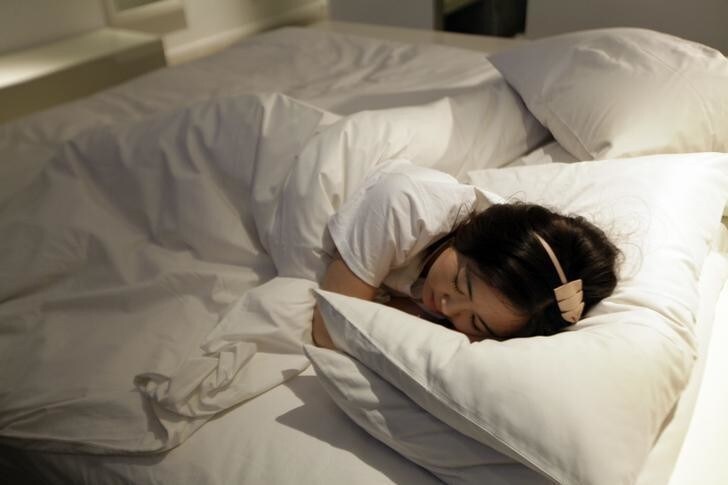 Ms. Zhuang sleeps on the bed as she shows a part of her job as a Hotel Test Sleeper at a boutique hotel in central Beijing March 6, 2012. Zhuang was selected as one of three final winners out of 7,800 candidates and started working for Qunar as a Professional Hotel Test Sleeper in March 2010. At present, she has slept at more than 200 hotels. "My job is to role-play travelers of different types, different ages and genders at different scenarios, and see how each hotel fits their particular needs." Zhuang said. Her reviews help travelers make smart hotel picks and bring them a more pleasant experience on the road. Qunar, a Chinese online travel platform, started to recruit Professional Hotel Test Sleepers in 2010. The requirement for this new profession is to sleep at selected hotels without disclosing their real job and write expert reviews about the facilities, location, dining, services and prices of the hotels, in order to provide an independent third-party evaluation and an authoritative guide to travelers, according to the company. Picture taken on March 6, 2012. REUTERS/Jason Lee (CHINA - Tags: TRAVEL BUSINESS EMPLOYMENT SOCIETY)