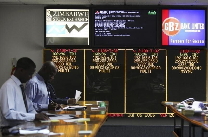 Stockbrokers trade on the floor of the Zimbabwe Stock Exchange (ZSE) in Harare, February 24, 2015. ZSE on Monday lifted the suspension of hotel group Meikles Africa after the company threatened to take court action, shelve new investment and a possible listing of a subsidiary. Meikles, which owns two premier hotels in the capital Harare and the resort town of Victoria Falls, was suspended last week to allow for an investigation on whether it overstated a debt owed by the central bank. REUTERS/Philimon Bulawayo (ZIMBABWE - Tags: BUSINESS) - GM1EB2O1NNF01