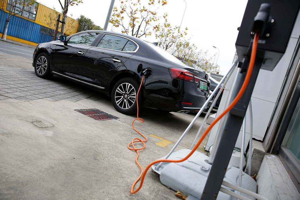 A Roewe 950 hybrid electric car is displayed with its plug-in charger at an electric car dealership in Shanghai, China, January 11, 2017. REUTERS/Aly Song - RTX2YGQH