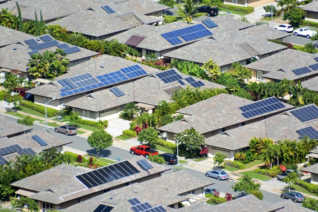 studies show that renewable energy, like these solar panels on houses in Hawaii, can create significant economic opportunites
