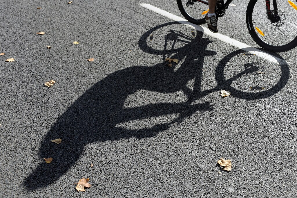 People ride their bicycles as the city centre is transformed into a car-free zone for the day as part of "Mobility Week" in Brussels September 21, 2014. The 19 communes of the city were transformed into a car-free zone and only residents with special permission were allowed to drive their cars, and even then only at 30 km (18.64 Miles) per hour. REUTERS/Eric Vidal (BELGIUM - Tags: ENVIRONMENT TRANSPORT) - GM1EA9M082401