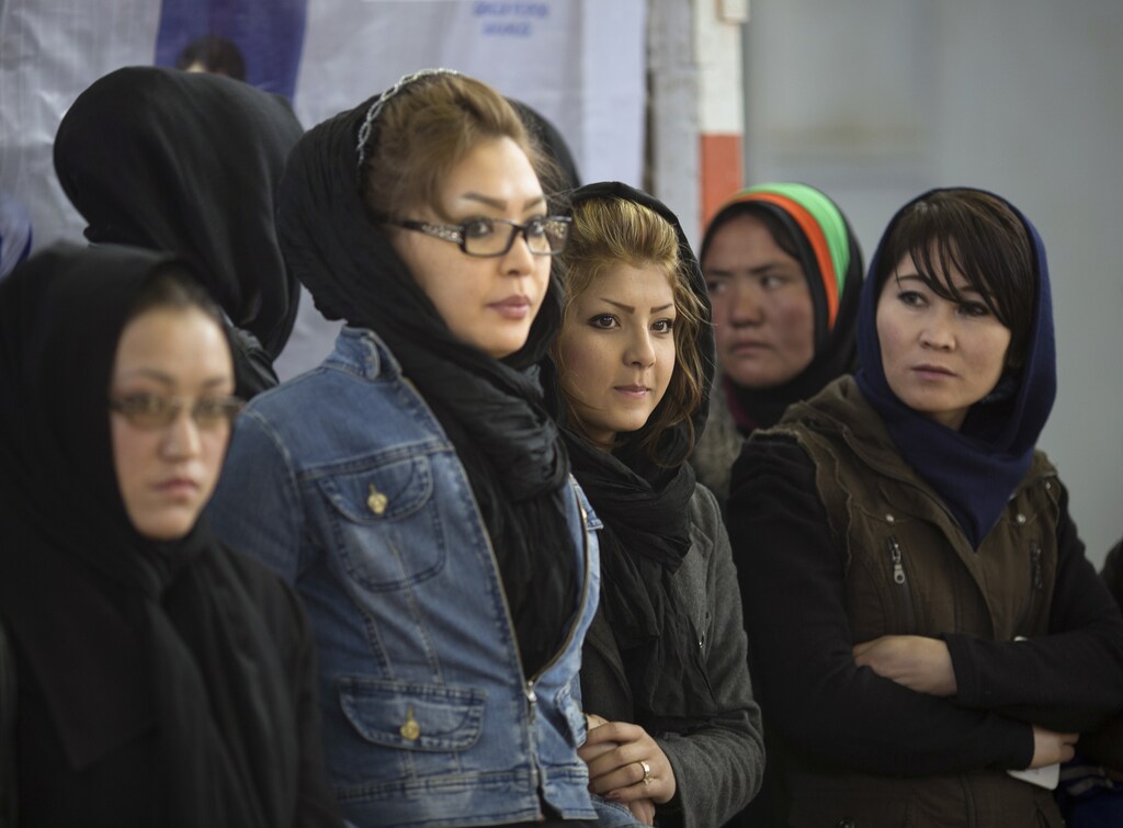 Afghan women watch a local sport ceremony in a stadium in Kabul March 8, 2014. Despite decades of conflict in Afghanistan, and several recent militant attacks, the country's capital Kabul is home to a vibrant youth scene of musicians, artists, athletes and activists. Shopping malls and cafes stand in the city, which is nonetheless beset by infrastructure problems and instability. Afghanistan is preparing for an election on April 5 that should mark the first democratic transfer of power in the country's history, but it has been hit by a tide of violence as the Islamist Taliban movement has ordered its fighters to disrupt the vote and threatened to kill anyone who participates. Picture taken March 8, 2014. REUTERS/Morteza Nikoubazl (AFGHANISTAN - Tags: SOCIETY POLITICS SPORT)ATTENTION EDITORS: PICTURE 27 OF 48 FOR PACKAGE "THE MODERN FACE OF KABUL"TO FIND ALL IMAGES SEARCH "KABUL NIKOUBAZL" - GM1EA3R0U3O01