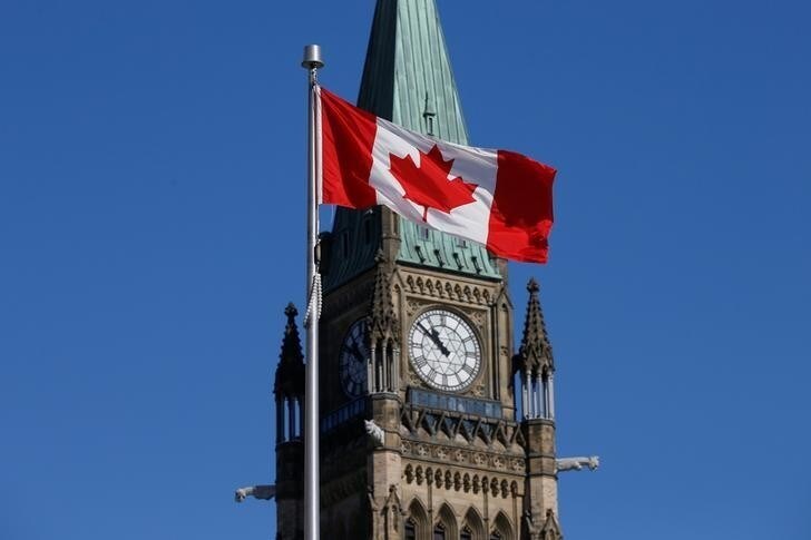 A Canadian flag flies in front of the Peace Tower on Parliament Hill in Ottawa, Ontario, Canada, March 22, 2017. REUTERS/Chris Wattie