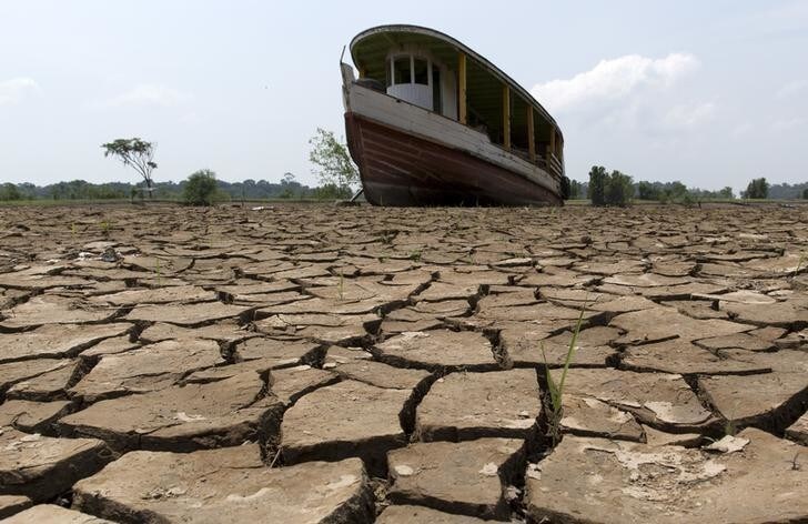A boat lies on the bottom of Amazonas river, in the city of Manaus, Brazil, October 26, 2015. A severe drought has pushed river levels in Brazil's Amazon region to lows, leaving isolated communities dependent on emergency aid and thousands of boats stranded on parched riverbeds. REUTERS/Bruno Kelly TPX IMAGES OF THE DAY