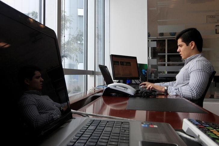 An account executive at the stock exchange works on his computer in the Invercasa building in Managua, Nicaragua November 22, 2017. REUTERS/Oswaldo Rivas