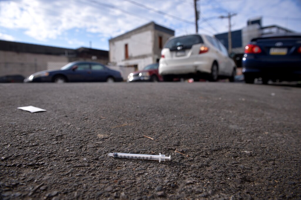 A needle used for shooting heroin and other opioids lies in the street in the Kensington section of Philadelphia, Pennsylvania, U.S., October 26, 2017. REUTERS/Charles Mostoller - RC1A8AC5B7E0