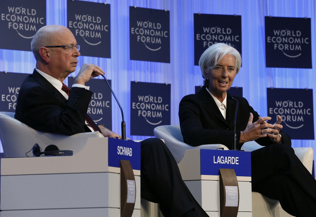 International Monetary Fund (IMF) chief Christine Lagarde addresses the annual meeting of the World Economic Forum (WEF), next to WEF founder Klaus Schwab (L), in Davos January 23, 2013. REUTERS/Pascal Lauener (SWITZERLAND - Tags: POLITICS BUSINESS) - LR1E91N1EJE1F