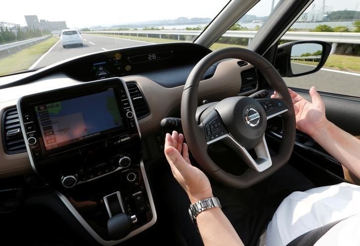 A Nissan employee removes his hands from the steering wheel as he test drives Nissan's new Serena minivan which is equipped with Propilot semi-automated driving functions, at the company's test drive facility in Yokosuka, Japan July 12, 2016. Picture taken July 12, 2016. REUTERS/Toru Hanai