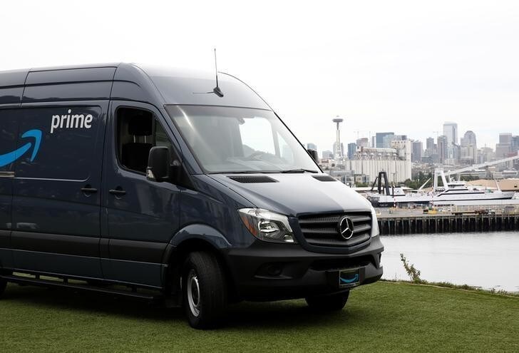 An Amazon Prime van sits on a hill overlooking downtown Seattle during a press conference announcing Amazon.com's new program to help entrepreneurs build businesses delivering Amazon packages, including $1 million to fund startup costs for military veterans, at an event space in Seattle, Washington, U.S., June 27, 2018. REUTERS/Lindsey Wasson