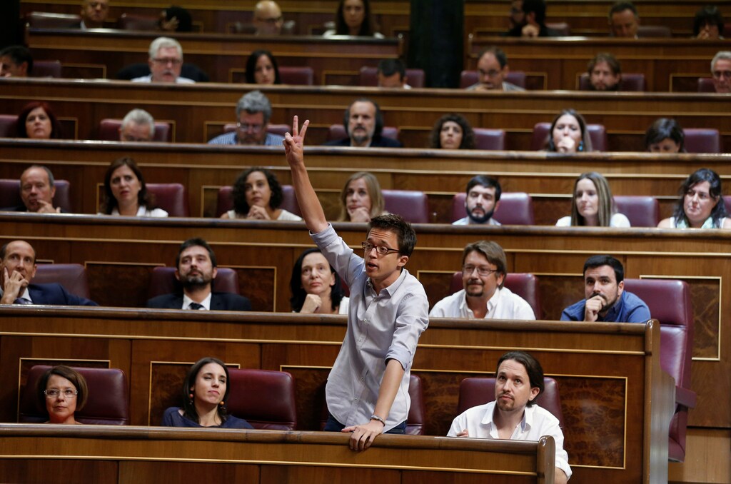 Podemos (We can) party deputy Inigo Errejon (2 R, front row) gestures while taking an oath during the first session of parliament following a general election in Madrid, Spain, July 19, 2016. REUTERS/Andrea Comas - RTSIOEL