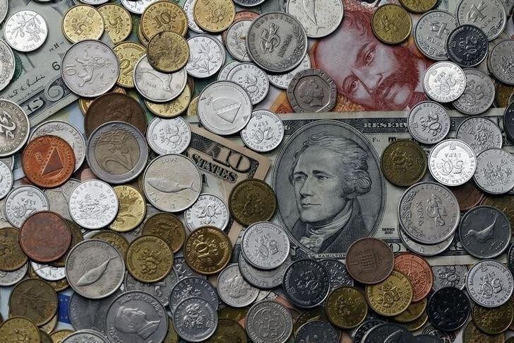 A picture illustration of coins from various countries laying on 10 Dollar and 100 kuna banknotes, taken in Zagreb January 18, 2011. REUTERS/Nikola Solic (CROATIA - Tags: BUSINESS)