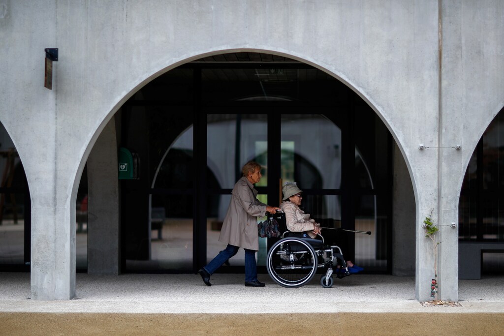 Alzheimer's patients Marie-Christiane pushes Jaqueline, 92, on her wheelchair during a walk at the Village Landais Alzheimer site in Dax, France, September 24, 2020. Picture taken on September 24, 2020. REUTERS/Gonzalo Fuentes - RC2K9J95H3ST