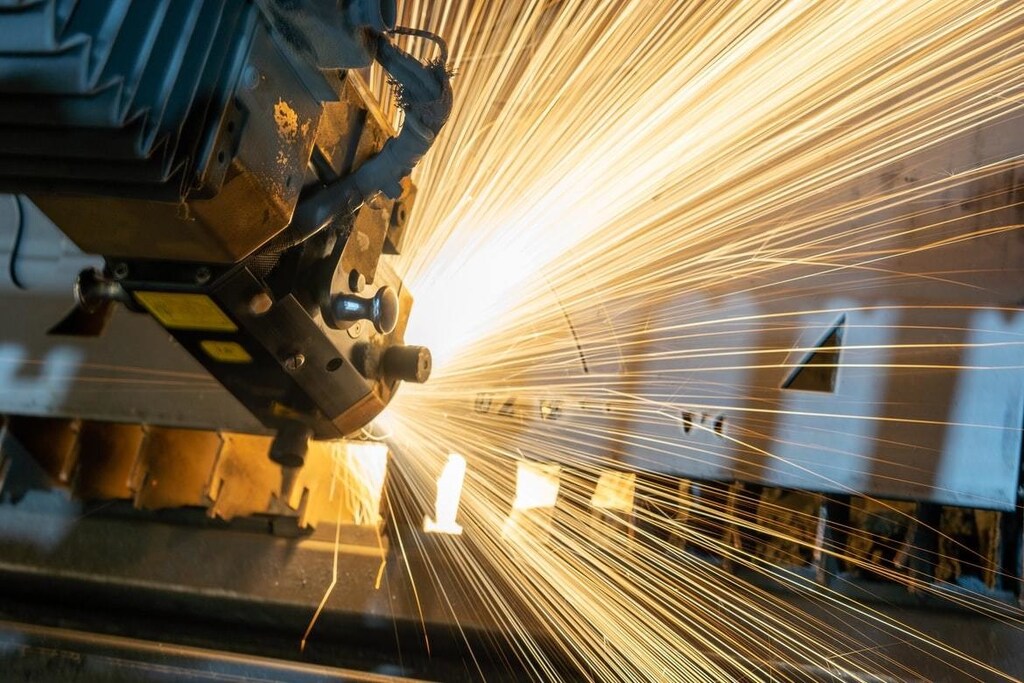 A robot arm is pictured in a factory.