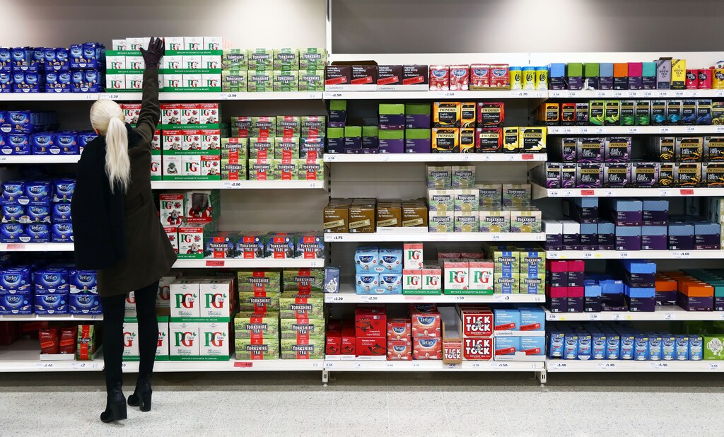 A shopper reaches for a box of tea in a supermarket in London, Britain April 11, 2017. British retail sales shrank at the fastest rate in nearly seven years during the past three months, despite a pickup in February, adding to signs that a major driver of Britain's economy is faltering after last year's Brexit vote. REUTERS/Neil Hall - LR1ED4B15A6BD