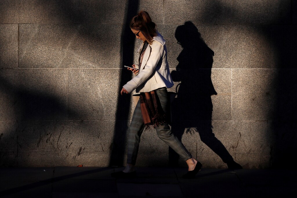 A woman looks at her mobile phone early morning in Westminster, London, Britain October 10, 2016. REUTERS/Stefan Wermuth SEARCH "WERMUTH PHONES" FOR THIS STORY. SEARCH "THE WIDER IMAGE" FOR ALL STORIES. - RC184A3646A0