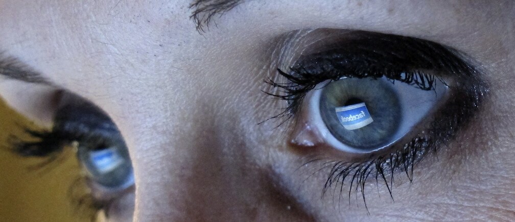 An illustration picture shows a woman looking at the Facebook website on a computer in Munich February 2, 2012. Facebook unveiled plans for the biggest ever Internet IPO that could raise as much as $10 billion, but made it clear CEO Mark Zuckerberg will exercise almost complete control over the company, leaving investors with little say.