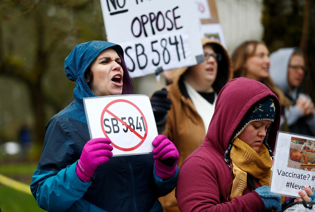 Krystal Glass of Vancouver, Washington, holds up an anti-SB 5841 sign during the "March for Medical Freedom" against mandatory vaccinations before the SB 5841 hearing in Olympia, Washington, U.S., February 20, 2019. REUTERS/Lindsey Wasson - RC1AEC610BB0