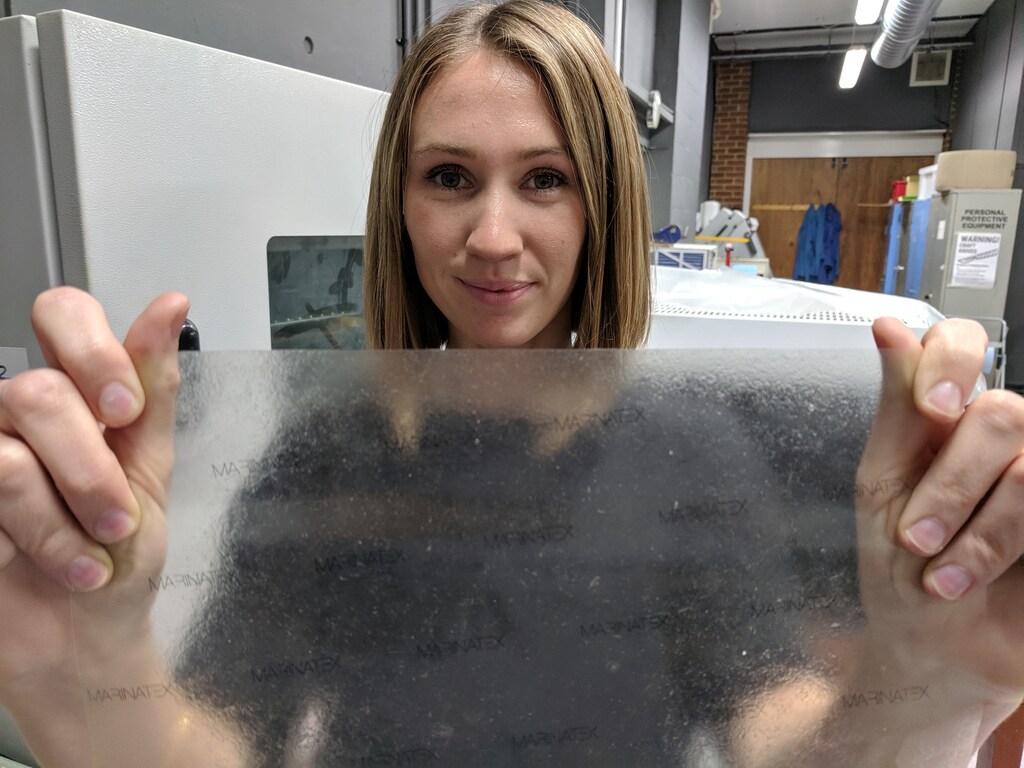 Product design graduate Lucy Hughes holds up a sheet of MarinaTex - an edible and compostable plastic alternative made from byproducts of the fishing industry and other natural ingredients which has won the James Dyson Award, in Brighton, Britain, October 24, 2019. Picture taken October 24, 2019. REUTERS/ Stuart McDill - RC2ZAD93VZOQ