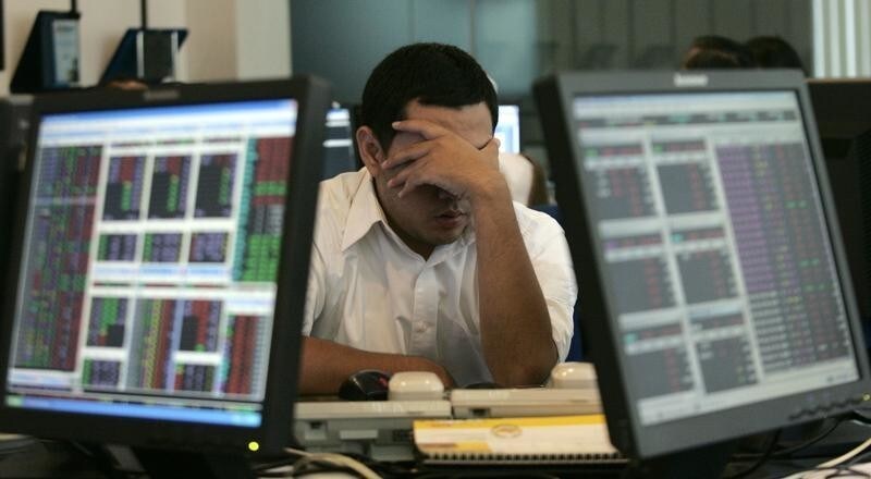 A broker rests after monitoring share prices during morning trading at a securities company in Jakarta October 13, 2008. Indonesian shares slid over 5 percent on Monday after a three-day trading halt as the government raised its guarantee on bank deposits to help restore confidence in the economy in the face of the global credit crisis. REUTERS/Dadang Tri (INDONESIA) - GM1E4AD13RI01