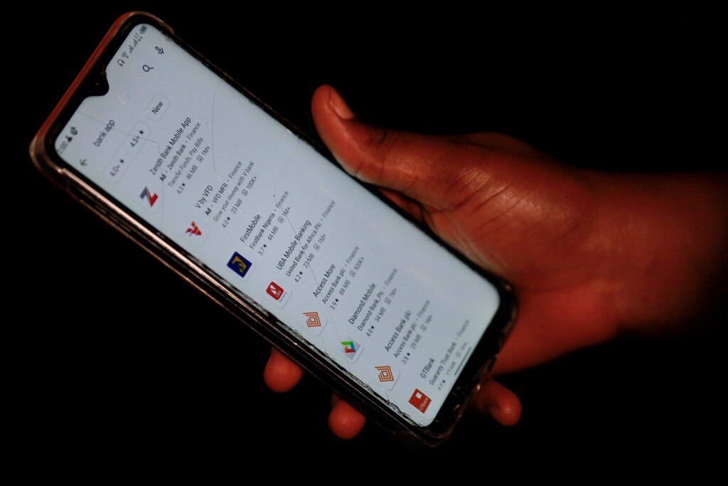 A woman shows a screen of her smartphone, where Access bank mobile app is seen among others, in Abuja, Nigeria September 21, 2020. Picture taken September 21, 2020. REUTERS/Afolabi Sotunde - RC2S3J9JGH63