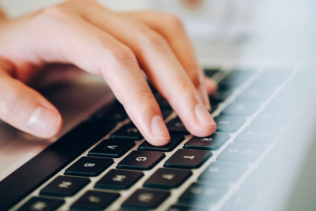 image of person typing on laptop