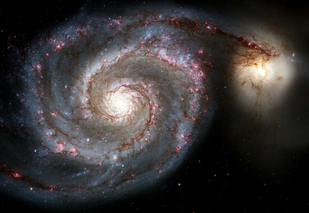A new view of the Whirlpool Galaxy, one of the two largest and sharpest images Hubble Space Telescope has ever taken, is released by NASA on Hubble's 15th anniversary April 25, 2005. The new Whirlpool Galaxy image showcases the spiral galaxy's curving arms where newborn stars reside and its yellowish central core that serves as home for older stars. During the 15 years Hubble has orbited the Earth, it has taken more than 700,000 photos of the cosmos. EDITORIAL USE ONLY REUTERS/NASA/Handout YH - RTR97ZX