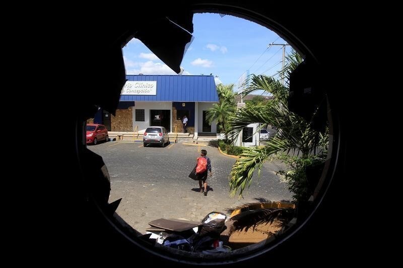 A man is seen through the window of a supermarket looted by demonstrators during the protests over a reform to the pension plans of the Nicaraguan Social Security Institute (INSS) in Managua, Nicaragua April 23, 2018.