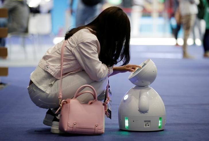 A staff member sets up a ROBOTLEO robot at the Global Mobile Internet Conference (GMIC) 2017 in Beijing, China April 28, 2017. REUTERS/Jason Lee