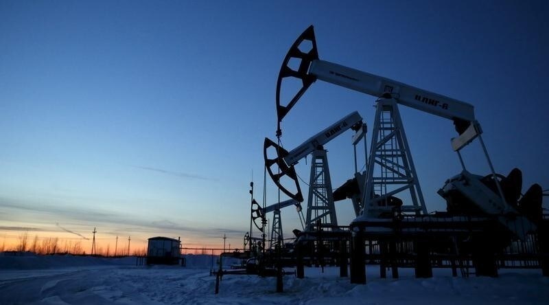 Pump jacks are seen at the Lukoil company owned Imilorskoye oil field, as the sun sets, outside the West Siberian city of Kogalym, Russia, January 25, 2016. Picture taken January 25, 2016.
