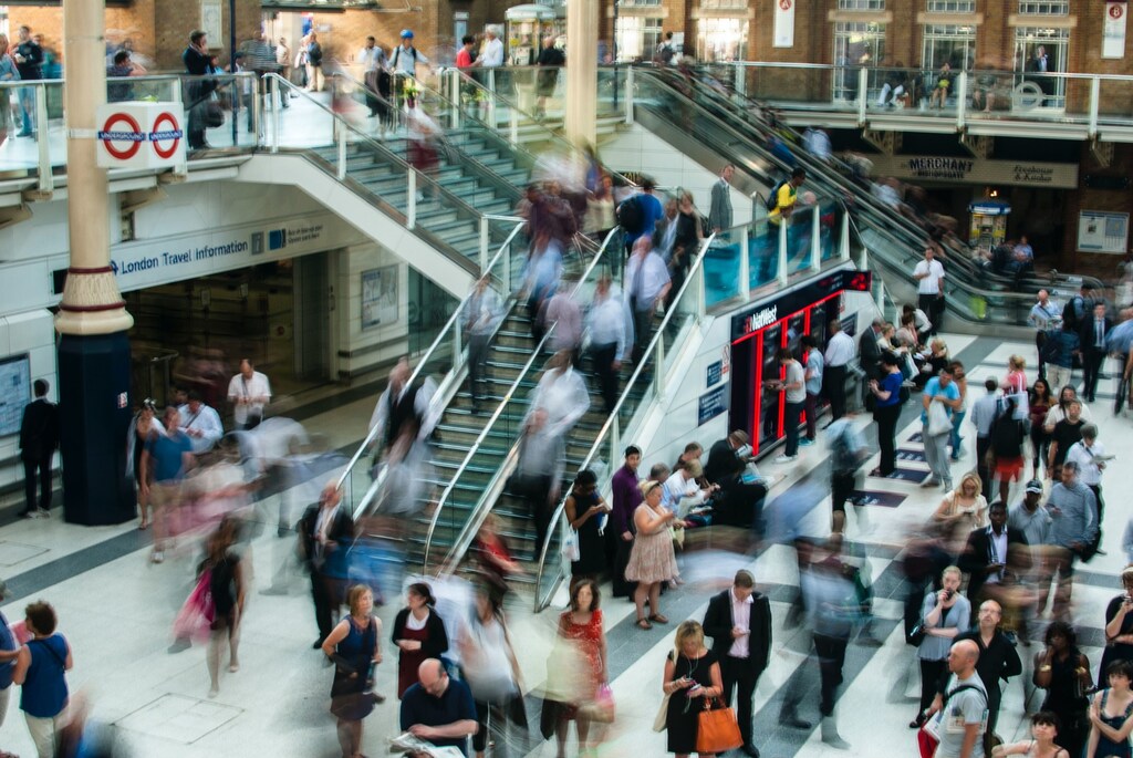 Commuters flow through a London Underground station in a story about productivity