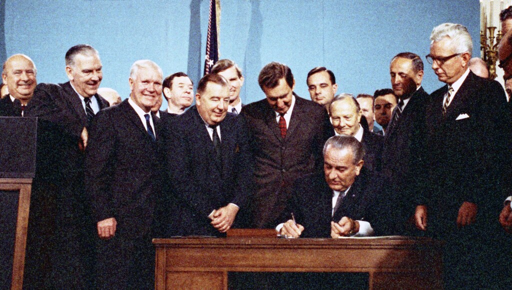 Lyndon Johnson signs the Clean Air Act in 1967, adding to a broad foundation for future climate laws.
