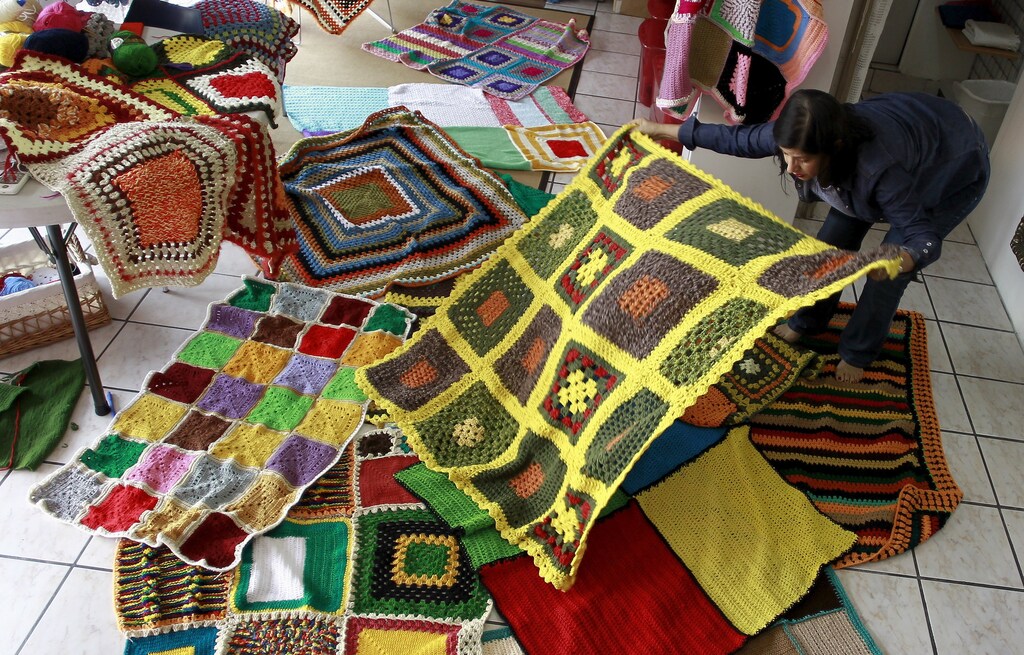Alejandra Gutierrez displays a blanket created for a campaign called "A Blanket for Syria", in San Jose October 28, 2015. A group of Costa Rican women are knitting blankets of varying sizes to send to an NGO in Madrid, which will ship them to camps for displaced people inside Syria, before cold weather begins, following an appeal for help, according to local media. REUTERS/Juan Carlos Ulate - GF20000036966