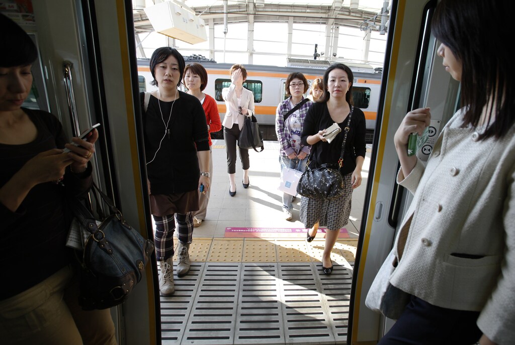 Workers board a "women-only" passenger train during rush hour in Tokyo.