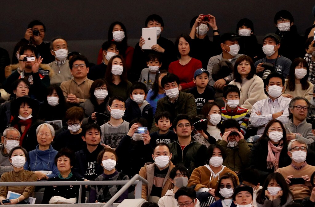 Visitors wearing surgical masks attend the opening ceremony of the Ariake Arena, which will host volleyball and wheelchair basketball competitions in Tokyo 2020 Olympic Games in Tokyo, Japan February 2, 2020. REUTERS/Kim Kyung-Hoon TPX IMAGES OF THE DAY - RC25SE906L4U