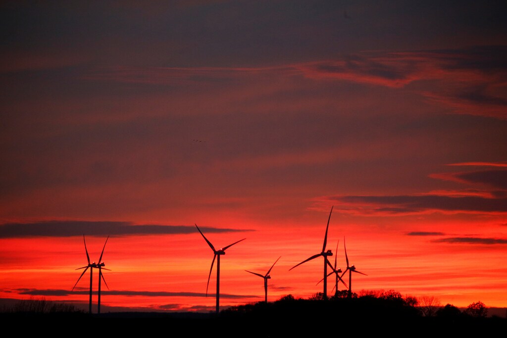 Power-generating windmill turbines are pictured at sunset at a wind park in Moeuvres near Cambrai, France, November 12, 2018