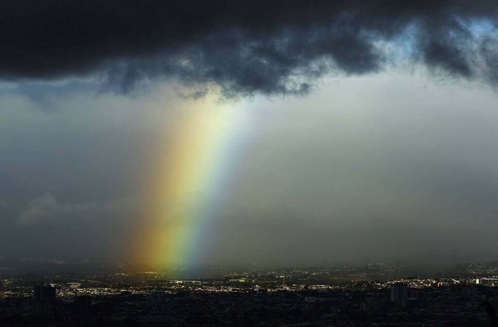 A rainbow is seen below dark clouds in San Jose city January 29, 2015. REUTERS/Juan Carlos Ulate (COSTA RICA - Tags: SOCIETY ENVIRONMENT) - GM1EB1U0PID01