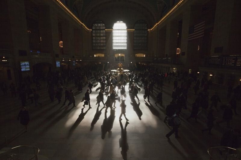 Morning commuters are silhouetted as they walk through the main concourse of the Grand Central Terminal, also known as Grand Central Station, in New York March 5, 2012. REUTERS/Adrees Latif