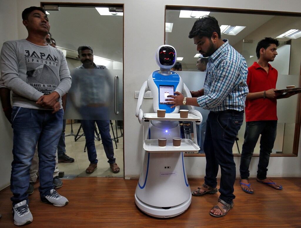 An engineer programs a robot waiter during a media preview at the Gujarat Science City in Ahmedabad, India, November 20, 2018. REUTERS/Amit Dave - RC1D67BD06B0