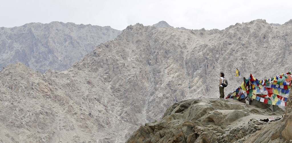 An Italian tourist stands on a hilltop overlooking Leh city, capital of Ladakh July 8, 2011