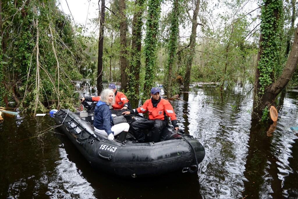 An elderly woman and her husband along with their pets are rescued by U.S. Coast Guard after their home was flooded by Hurricane Florence, in Brunswick County, North Carolina, U.S., September 16, 2018. Picture taken September 16, 2018. Courtesy Trevor Lilburn/U.S. Coast Guard District 5/Handout via REUTERS ATTENTION EDITORS - THIS IMAGE HAS BEEN SUPPLIED BY A THIRD PARTY. MANDATORY CREDIT. - RC1BBF6FBC80