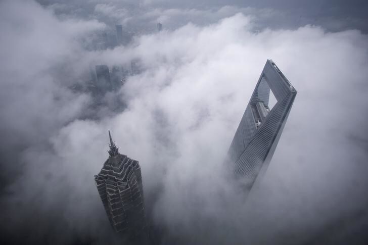 Skyscrapers Shanghai World Financial Center (R) and Jin Mao Tower are seen during heavy rain at the financial district of Pudong in Shanghai May 15, 2015. REUTERS/Aly Song TPX IMAGES OF THE DAY