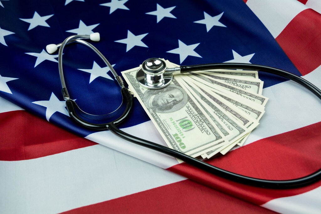The national flag of the U.S., with U.S. dollars on top, also a stethoscope