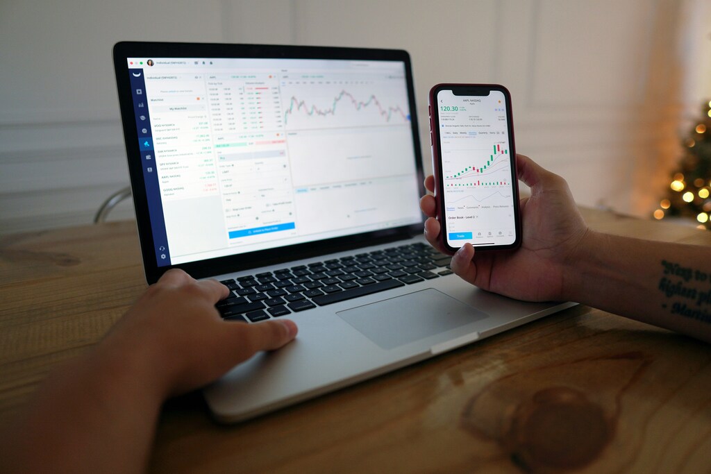 A person looking at screens for investing information