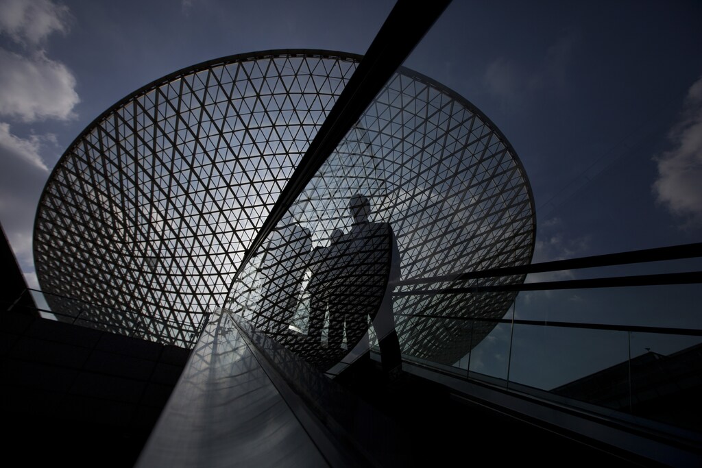 People ride an escalator near the Expo Axis in Shanghai November 20, 2014.