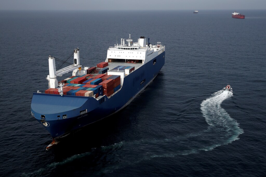 a cargo ship sails on water